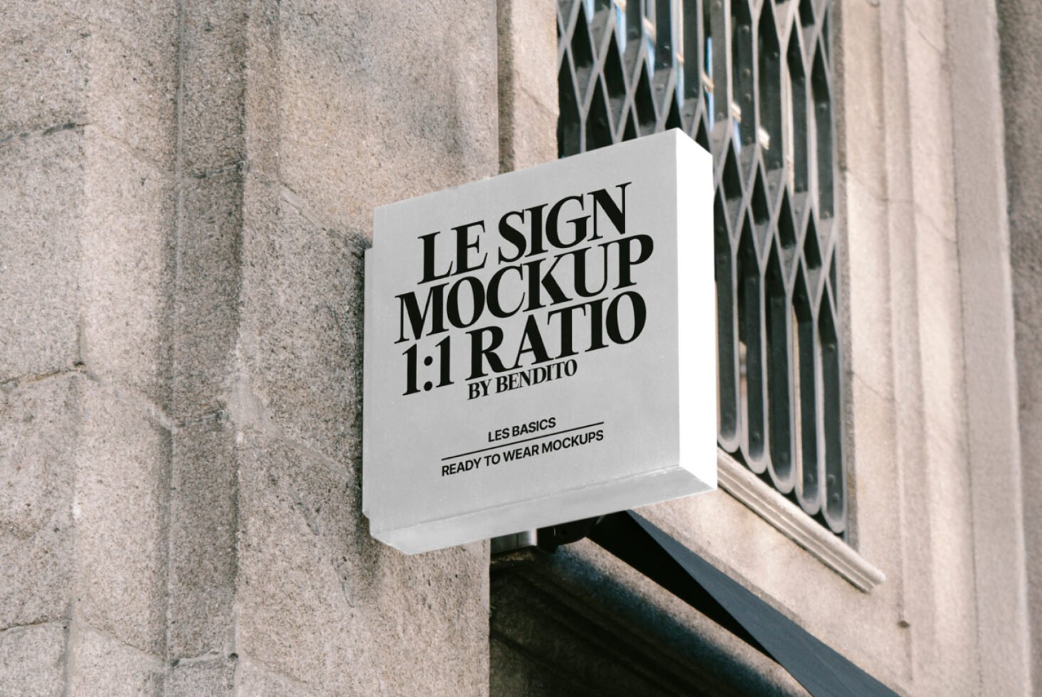 Outdoor shop sign mockup on a stone wall displaying Le Sign Mockup 1:1 Ratio. Ideal for designers seeking high-quality signage templates.