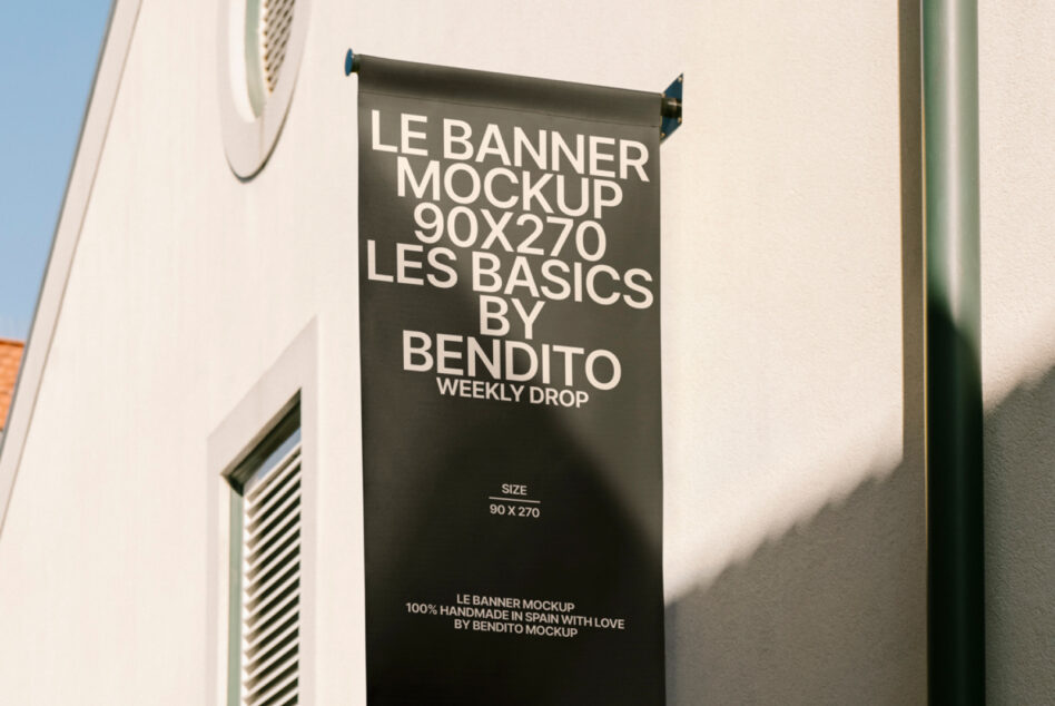 Dark gray hanging banner mockup 90x270 mounted on concrete building facade