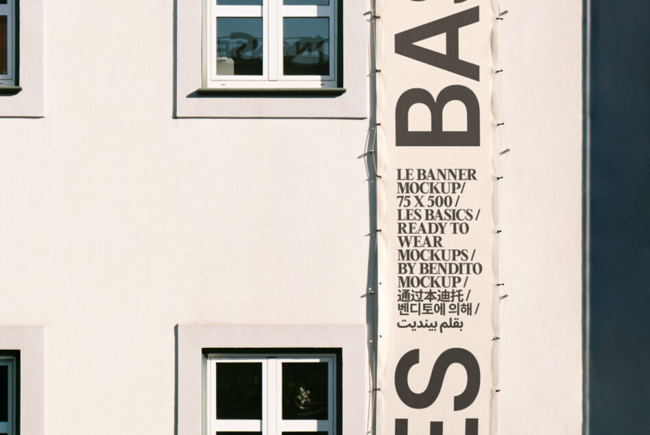 Cropped view of cream vertical banner on building showing large bold lettering