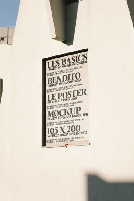 Vertical black poster mockup on white wall with bold sans serif typography layout