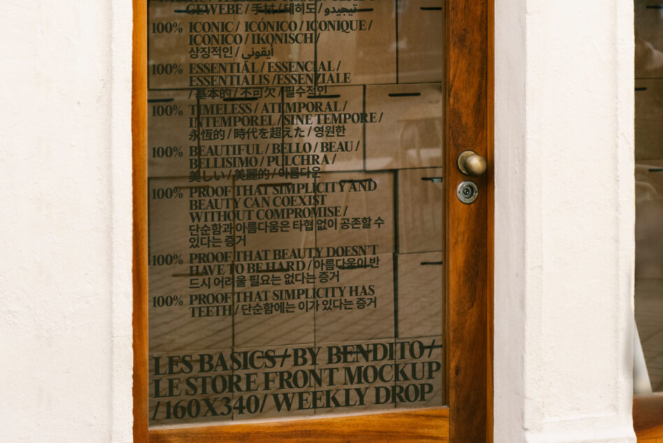 Door glass showing multilingual text for Les Basics brand messaging