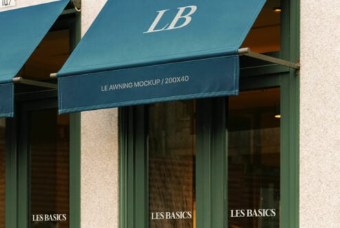 Blue awning mockup with branding text over a storefront window. Ideal for showcasing retail designs. Keywords: mockup, branding, outdoor, design.