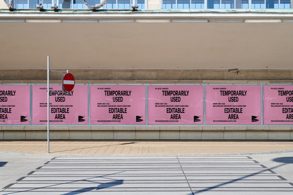 Row of pink billboards with black text saying temporarily used editable area on storefront