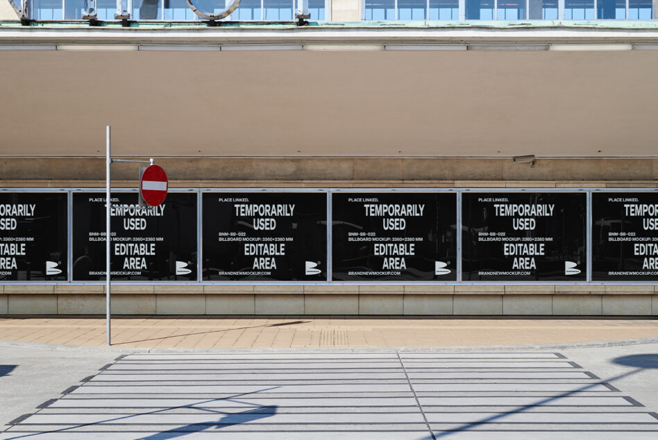 Row of black billboards with white text saying temporarily used editable area on storefront