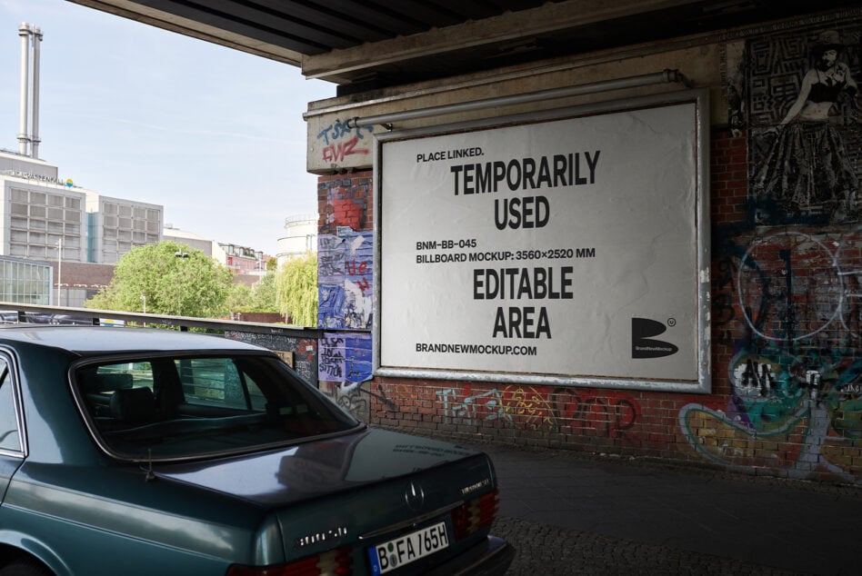 White billboard mockup under concrete overpass with parked car below