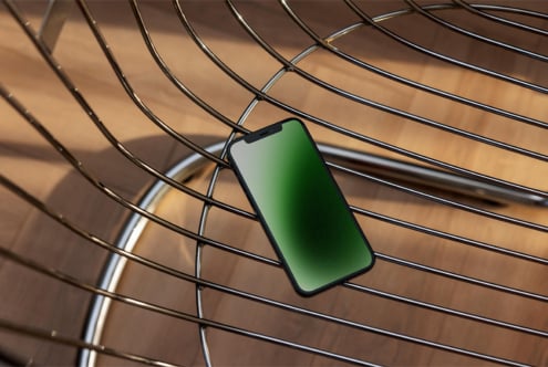 Smartphone mockup with green screen on modern wire chair design asset for designers showcasing sleek digital visualization templates and graphics