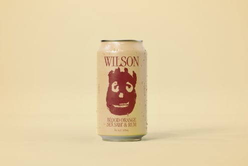 Mockup of a can labeled Wilson featuring a bold red logo and text reading Blood Orange Sea Salt Rum ideal for branding design and product packaging presentations
