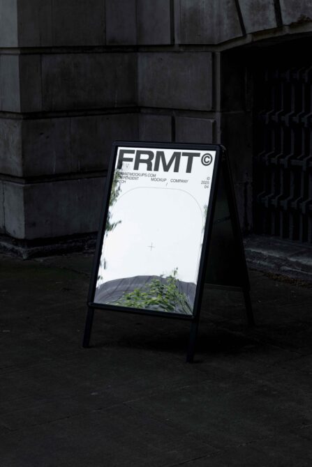 Sidewalk sandwich board sign with white mockup space, FRMT branding at top, concrete setting