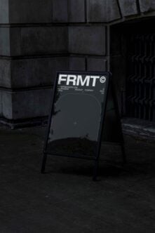 Outdoor sign mockup featuring FRMT typography leaning against a concrete wall. Ideal for designers seeking urban-style templates for branding projects.