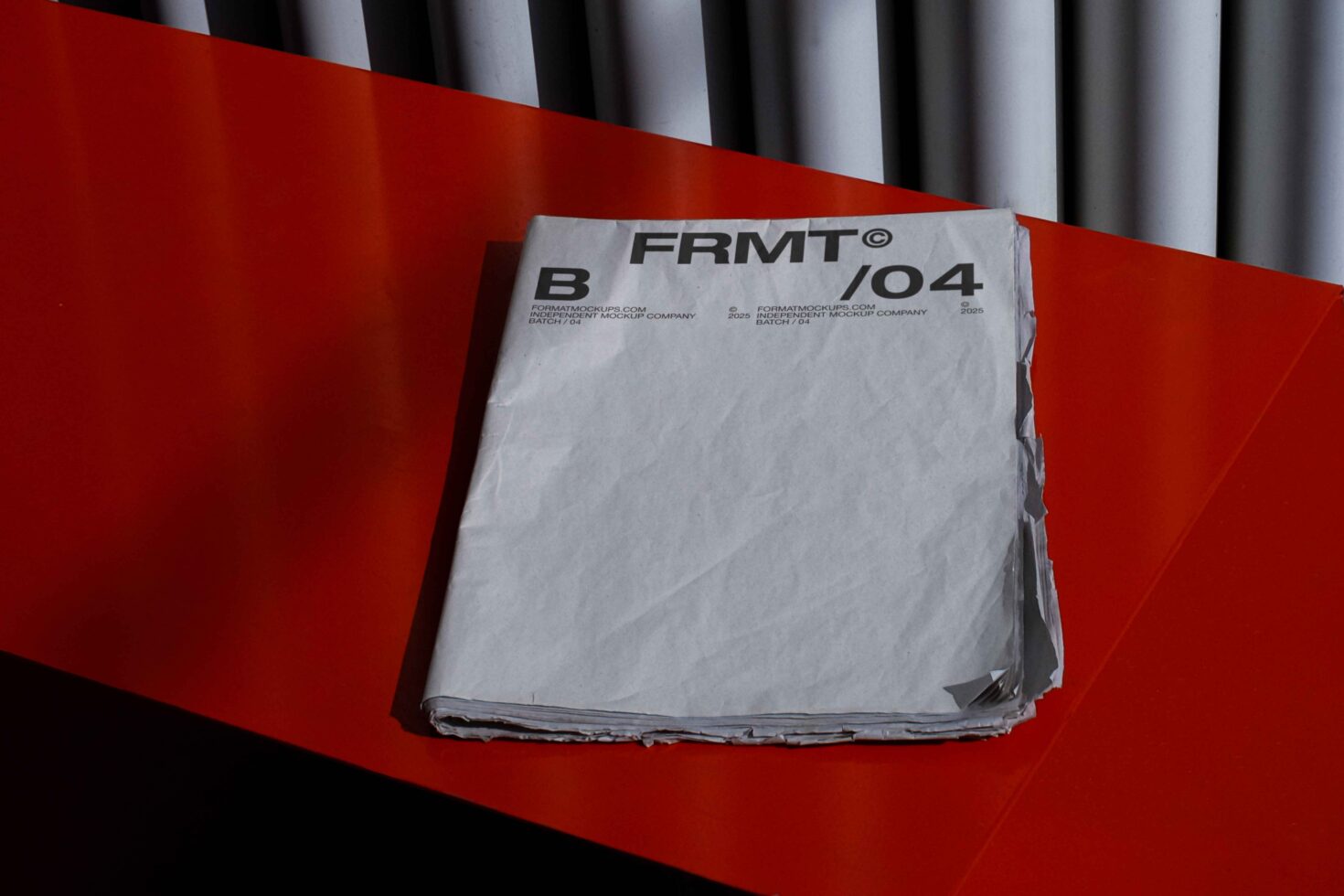 Stack of white papers with FRMT branding label on bright red background with striped backdrop