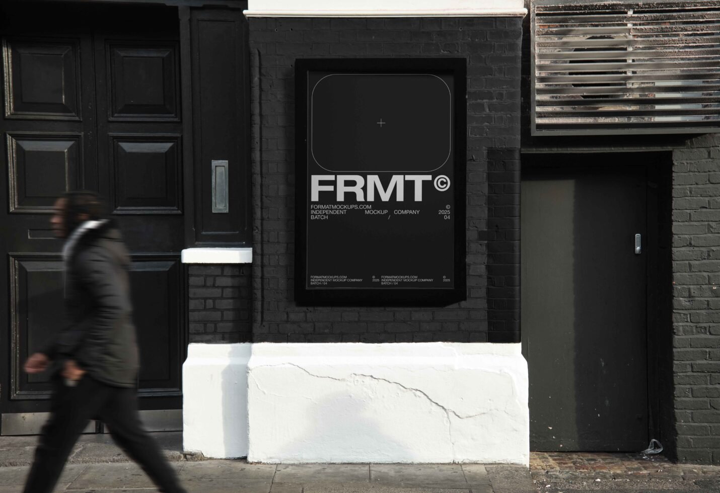 Urban poster mockup displayed on a black brick wall with a blurred pedestrian. Perfect for showcasing graphic design templates or creative artworks.