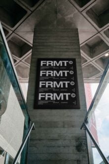 Industrial stairway with large architectural poster featuring FRMT design. Ideal for designers seeking modern graphics or mockup templates in urban settings.