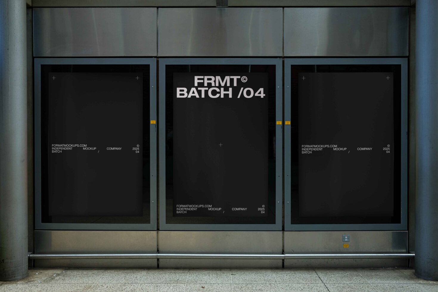 Three large posters displayed in concrete window frames at street level
