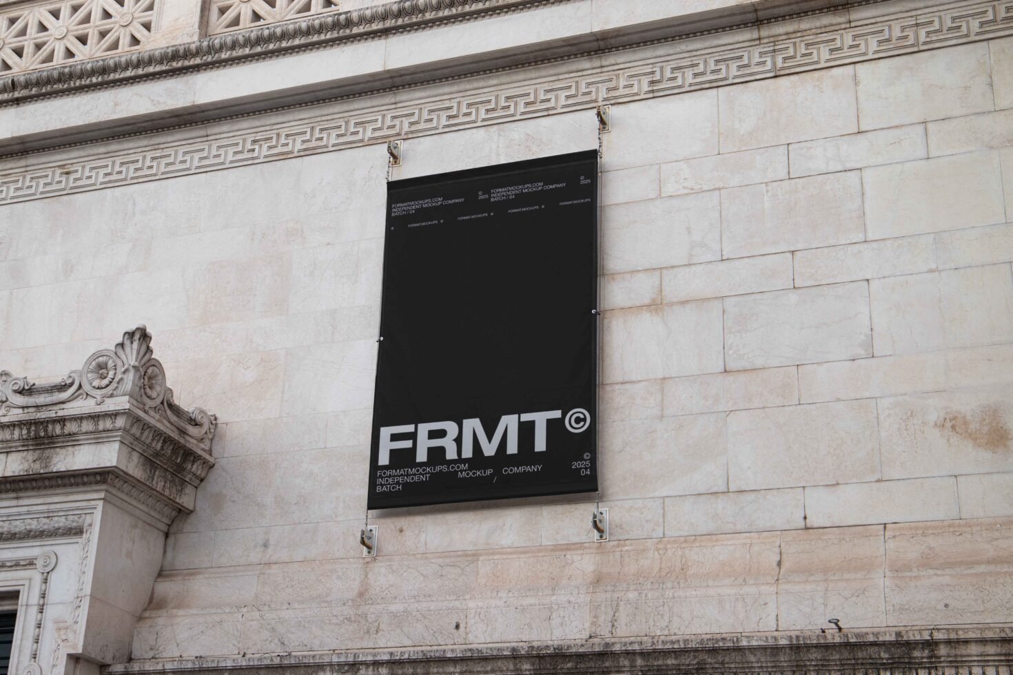 Black banner mockup on ornate stone building wall, perfect for graphic designers seeking urban presentation templates and outdoor display graphics.