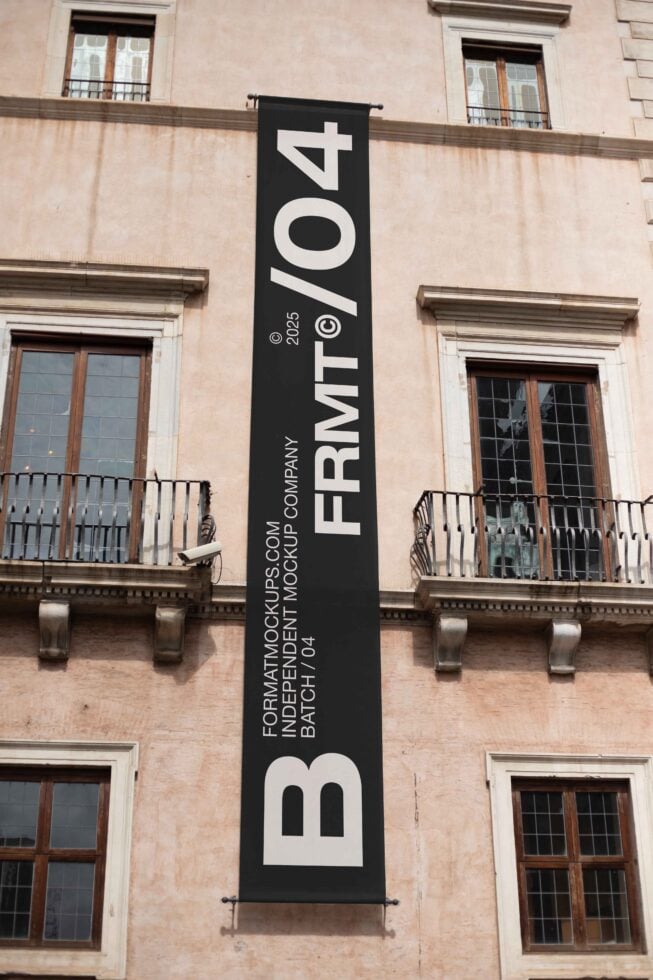 Black vertical banner on historic building with FRMT04 logo in white sans-serif