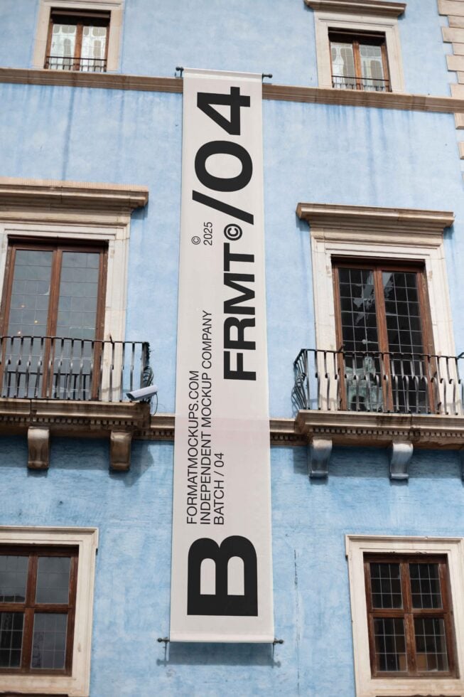 Cream vertical banner on blue painted historic building facade