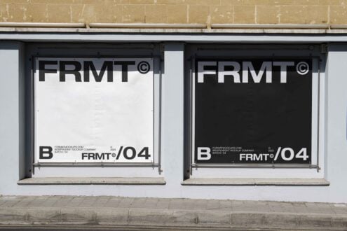 Urban storefront with two large poster mockups in black and white. Minimalist design ideal for showcasing branding materials and graphic templates.
