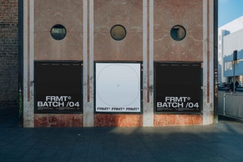 Three storefront posters on marble wall, black center with white circle, left right black with text