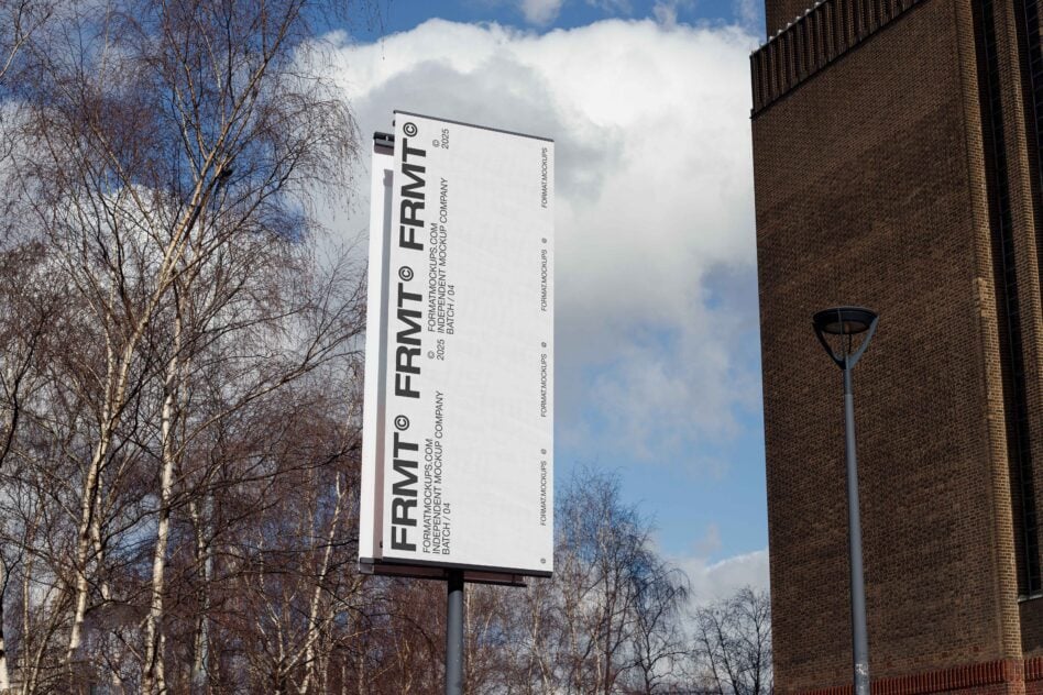 Vertical billboard mockup against blue sky with bare trees brick building