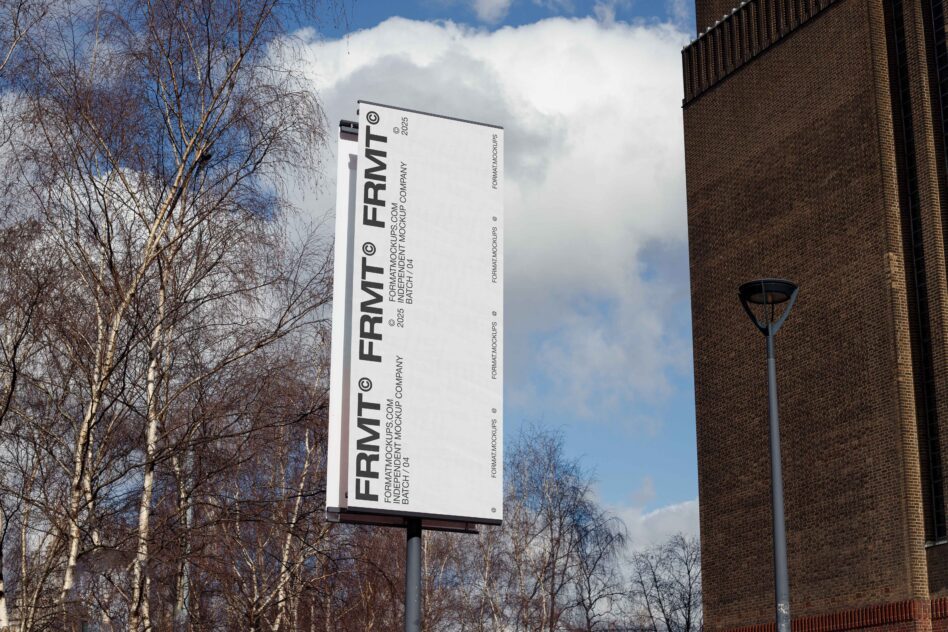 Large outdoor billboard mockup on pole with bare trees in winter landscape