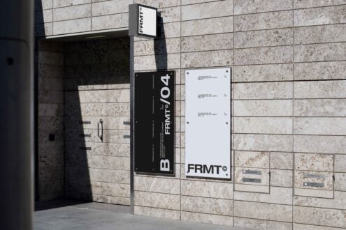 Building facade with modern sign mockup template featuring bold typography on textured stone wall. Ideal for showcasing branding and signage design.