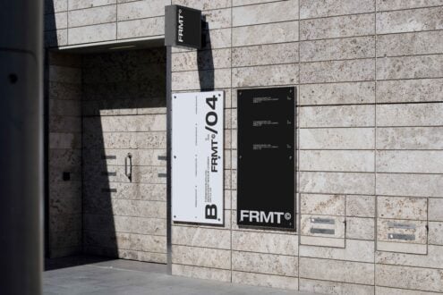 Modern building facade with minimalist signage mockup featuring large vertical text on white and black panels ideal for branding and architectural design.