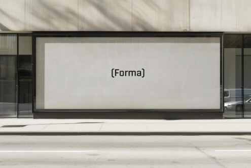 Storefront mockup with large glass window displaying the word Forma in minimalist black font. Perfect for designers seeking modern presentation templates.