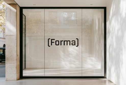 Modern storefront glass window mockup with 'Forma' text. Ideal for showcasing logo designs, fonts, or branding templates for graphic designers.
