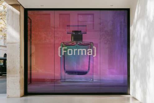 Perfume bottle mockup with a modern glass design behind a storefront window. Vibrant gradients and bold typography. Ideal for product presentation.