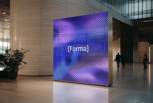 Digital signage mockup in modern lobby with blue abstract graphics and Forma text. Ideal for showcasing design concepts in urban environments.