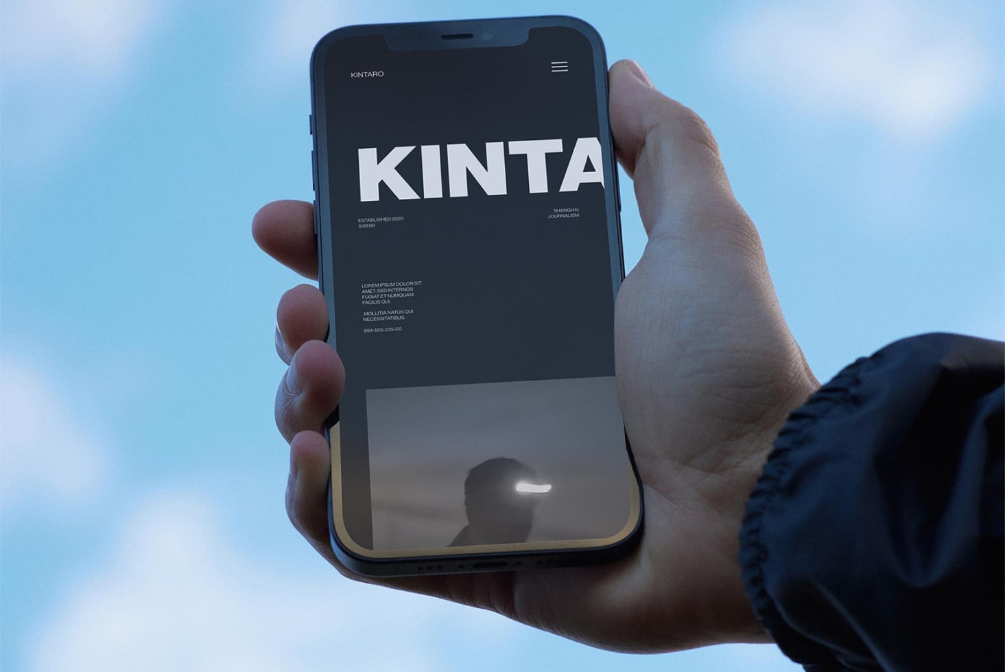iPhone mockup showing Kinta design studio website with bold typography on dark background
