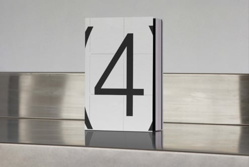Minimalist book cover mockup featuring large black number 4 on white background placed on reflective metallic surface suitable for designers.