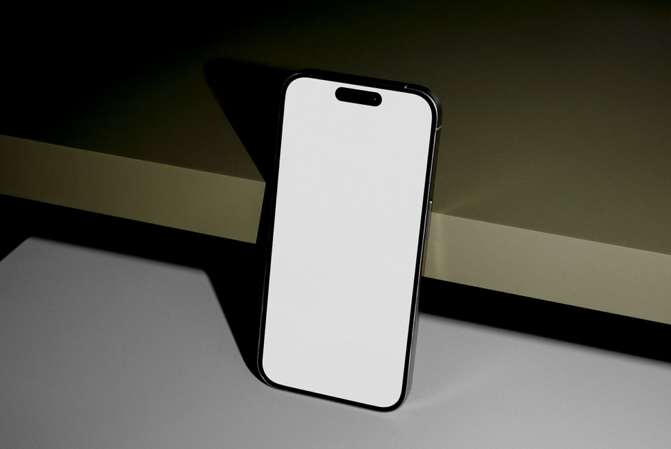 Blank iPhone screen mockup on minimalist background with shadow