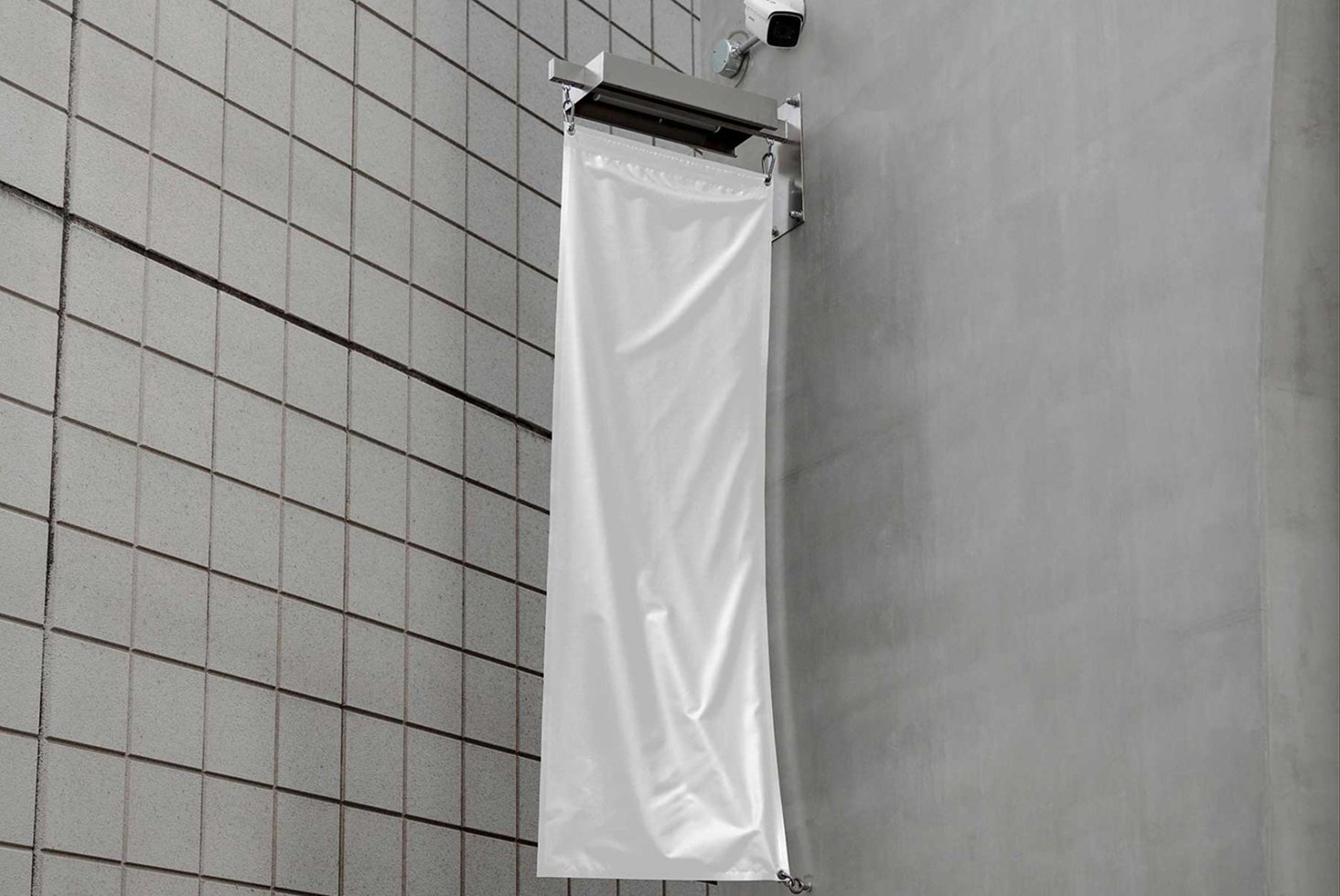 White vertical flag mockup on a modern tiled wall background perfect for designers seeking realistic graphics for outdoor advertisements and branding.