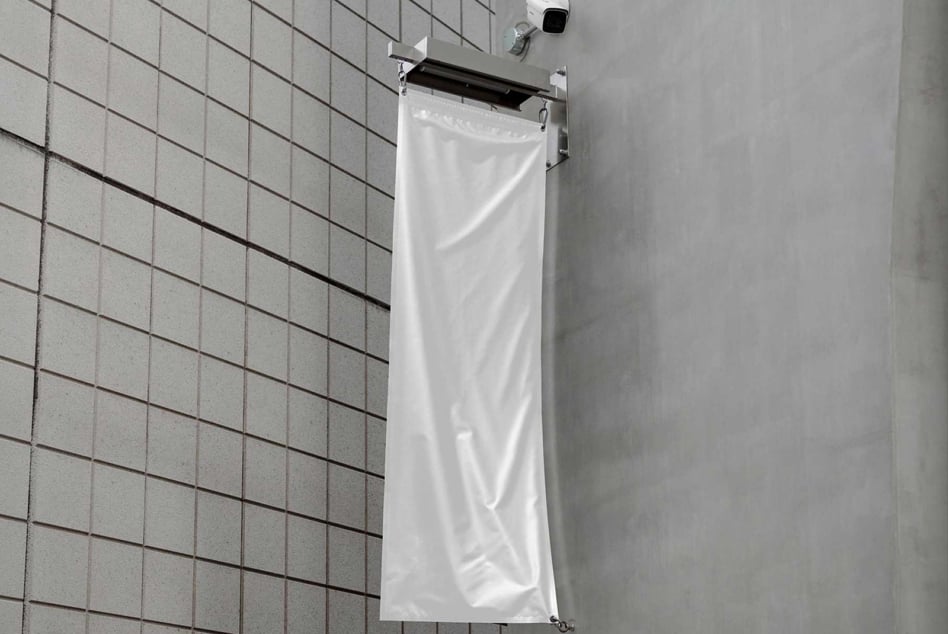 White vertical flag mockup on a modern tiled wall background perfect for designers seeking realistic graphics for outdoor advertisements and branding.
