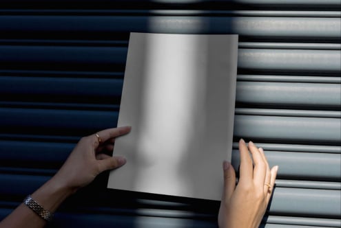 Mockup image featuring hands holding a blank A4 paper against a textured background shadows design digital assets template creative graphic design ready
