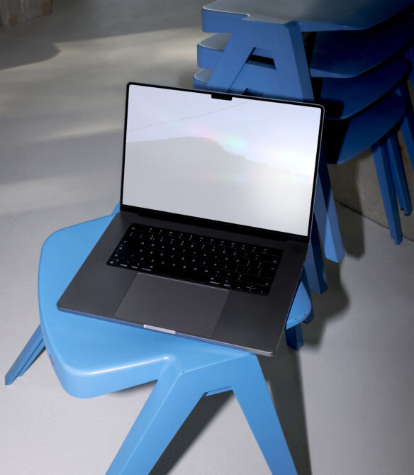 Laptop mockup on modern blue chair stack in minimalist setting, digital design asset for creatives, graphic templates, tech workspace inspiration