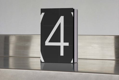 Minimalist book mockup featuring a black cover with large white number four. Ideal for showcasing book cover designs in creative portfolios.