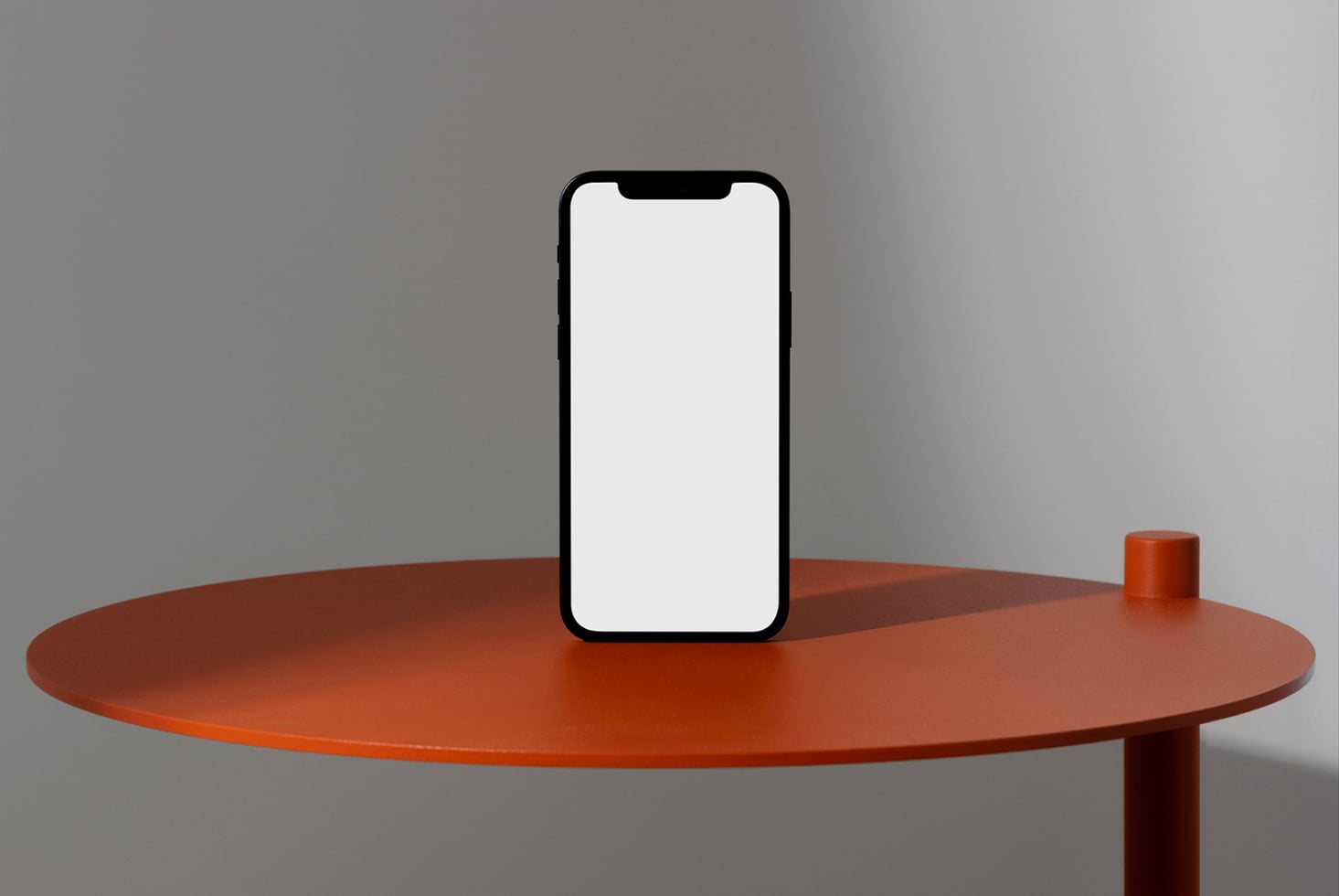 Mobile phone mockup centered on orange round table with blank white screen