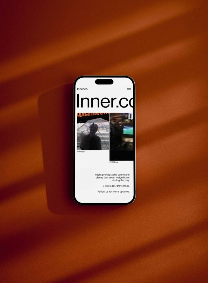 Smartphone screen mockup displaying a website with a modern minimalist design on a warm brown background. Ideal for designers showcasing digital projects.