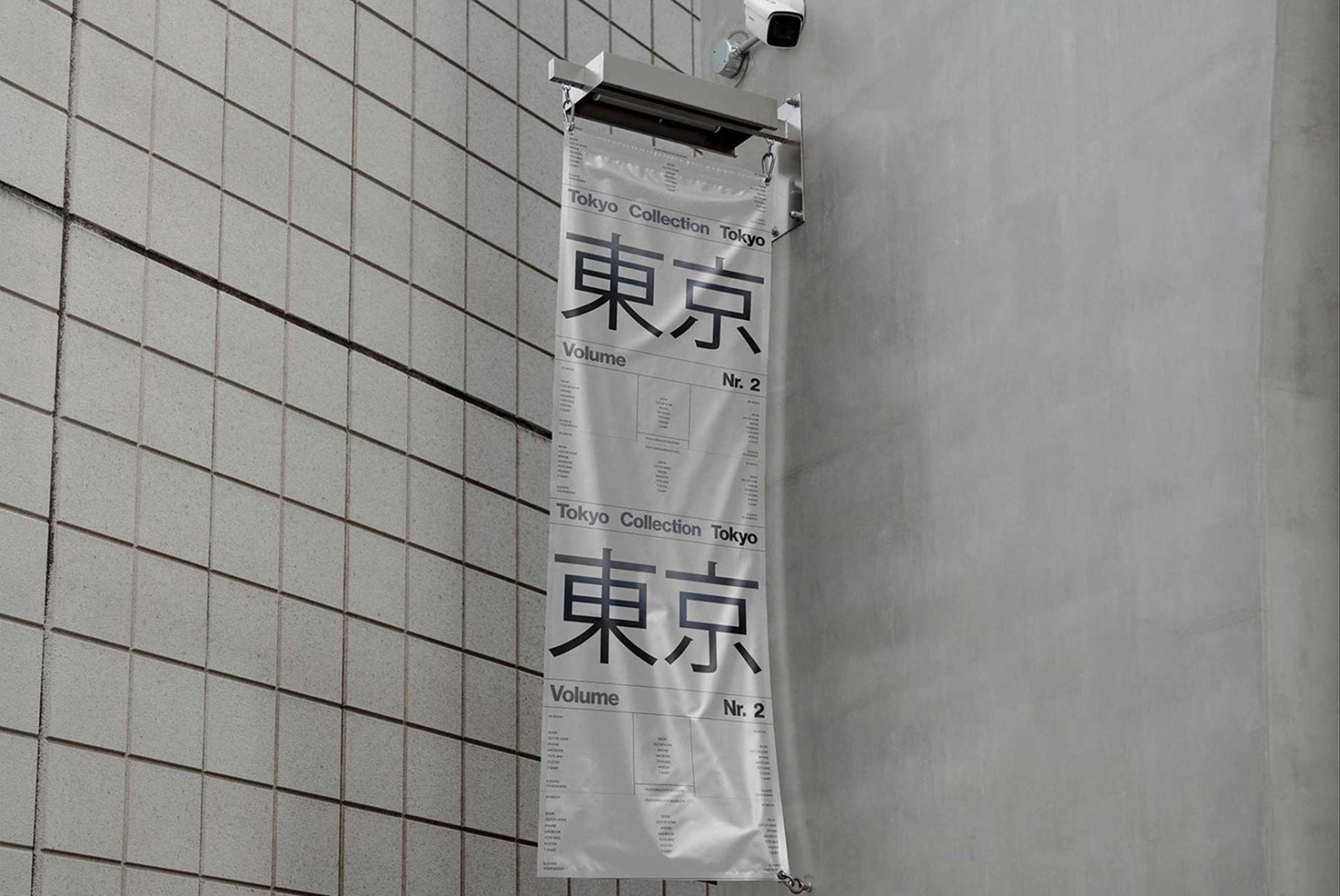 Hanging banner mockup displaying Tokyo Collection text on a tiled wall perfect for showcasing urban design projects or typography.