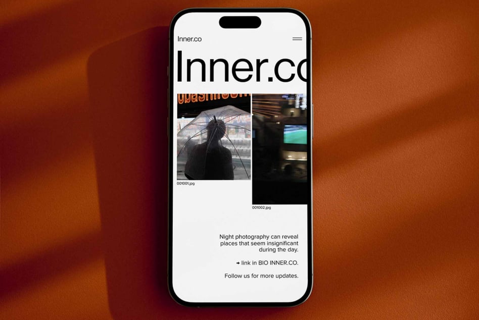 Smartphone displaying minimalist photography blog with dark urban images and text about night photography insights. Perfect for design inspiration and media.