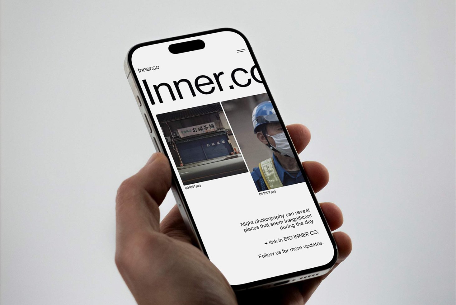 Hand holding smartphone displaying website with images for digital design. Ideal for mockups, showcasing creative online portfolios and UI/UX design drafts.