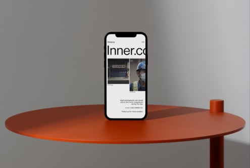 Smartphone mockup on a minimalist orange table showcasing a modern website design. Ideal for graphic designers digital assets mockups templates.