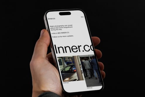 Smartphone in hand displaying a modern website with bold typography. Digital design mockup ideal for UX UI designers. Minimalist interface showcase.
