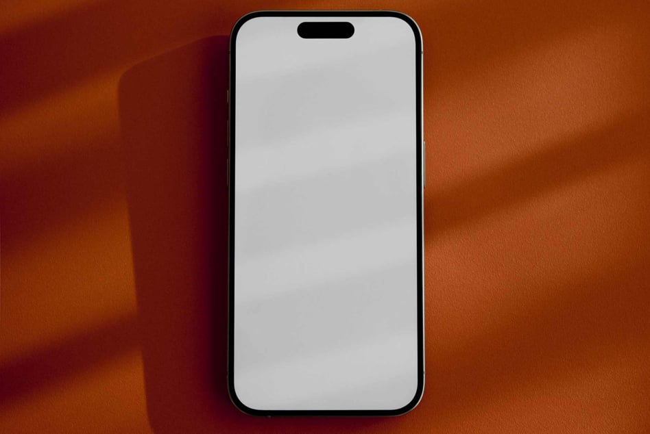 Smartphone mockup on a brown surface showcasing a blank display for app designs and presentations perfect for digital asset marketplaces and designers