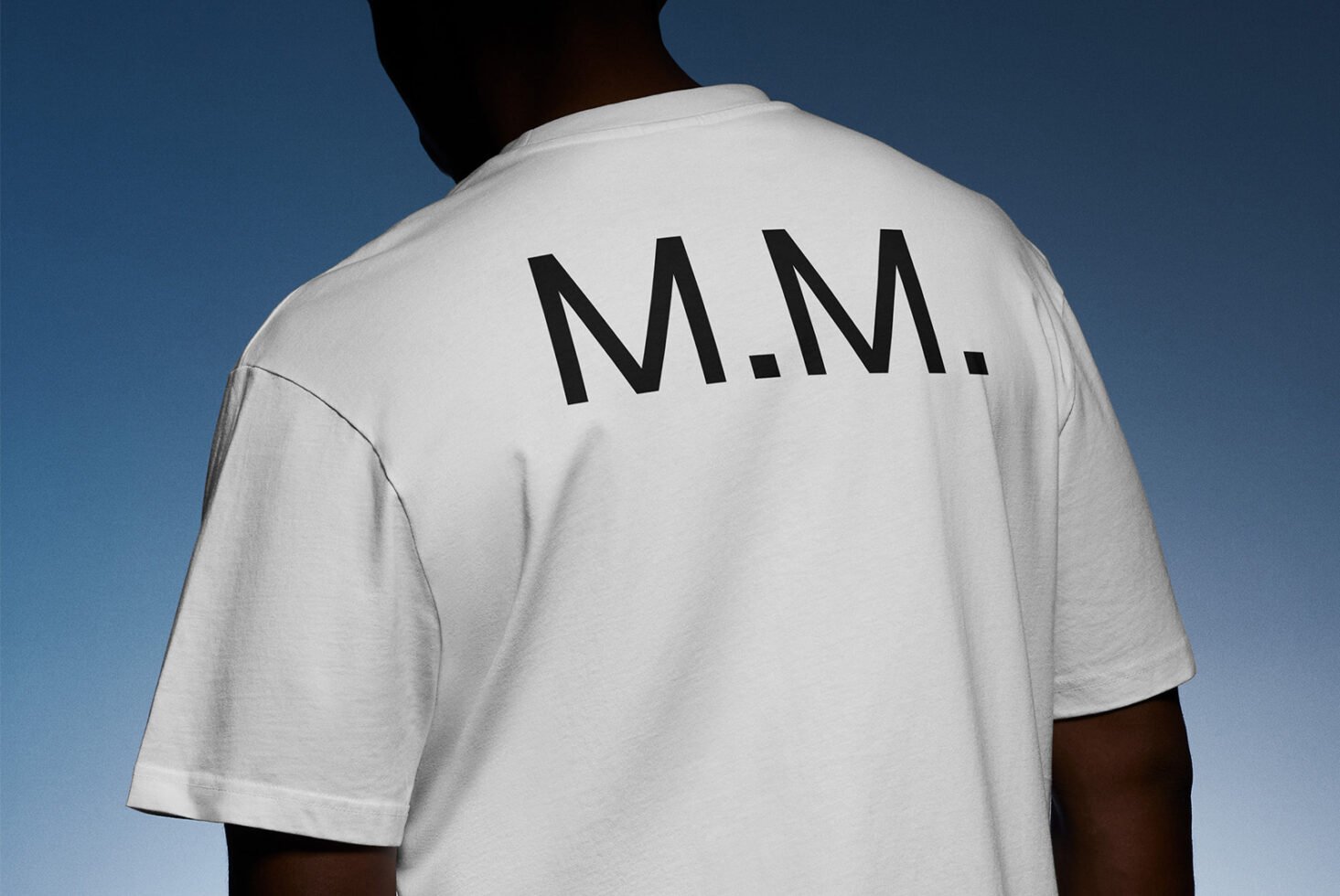 White T-shirt with black M M lettering mockup perfect for graphic designers fashion templates apparel design featuring clear text placement on cotton fabric.