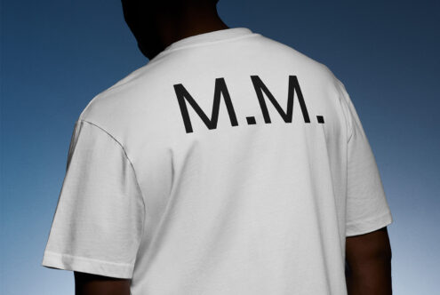 White T-shirt with black M M lettering mockup perfect for graphic designers fashion templates apparel design featuring clear text placement on cotton fabric.