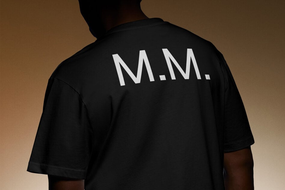 Back view of person wearing black shirt with white lettering MM suitable for apparel mockup designers showcasing bold typography fashion template design