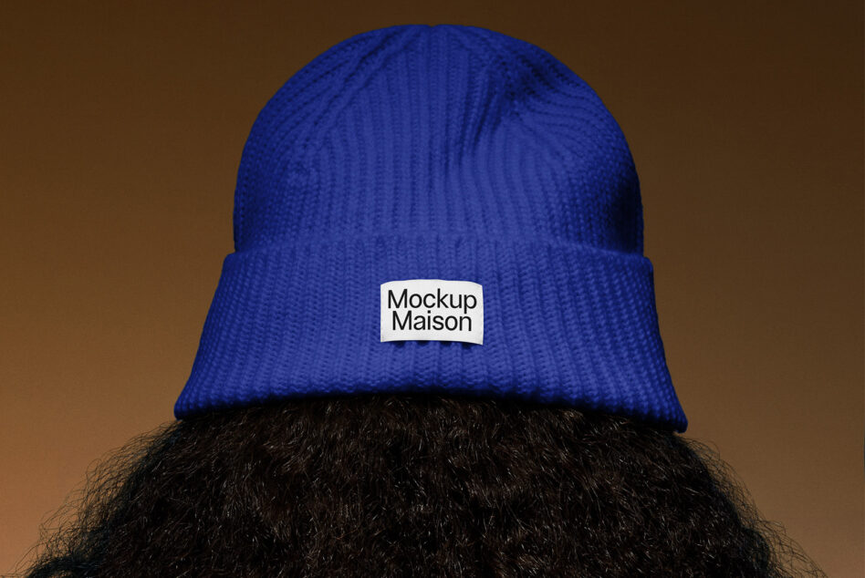 Royal blue knit beanie with white woven patch on cuff detail overhead view